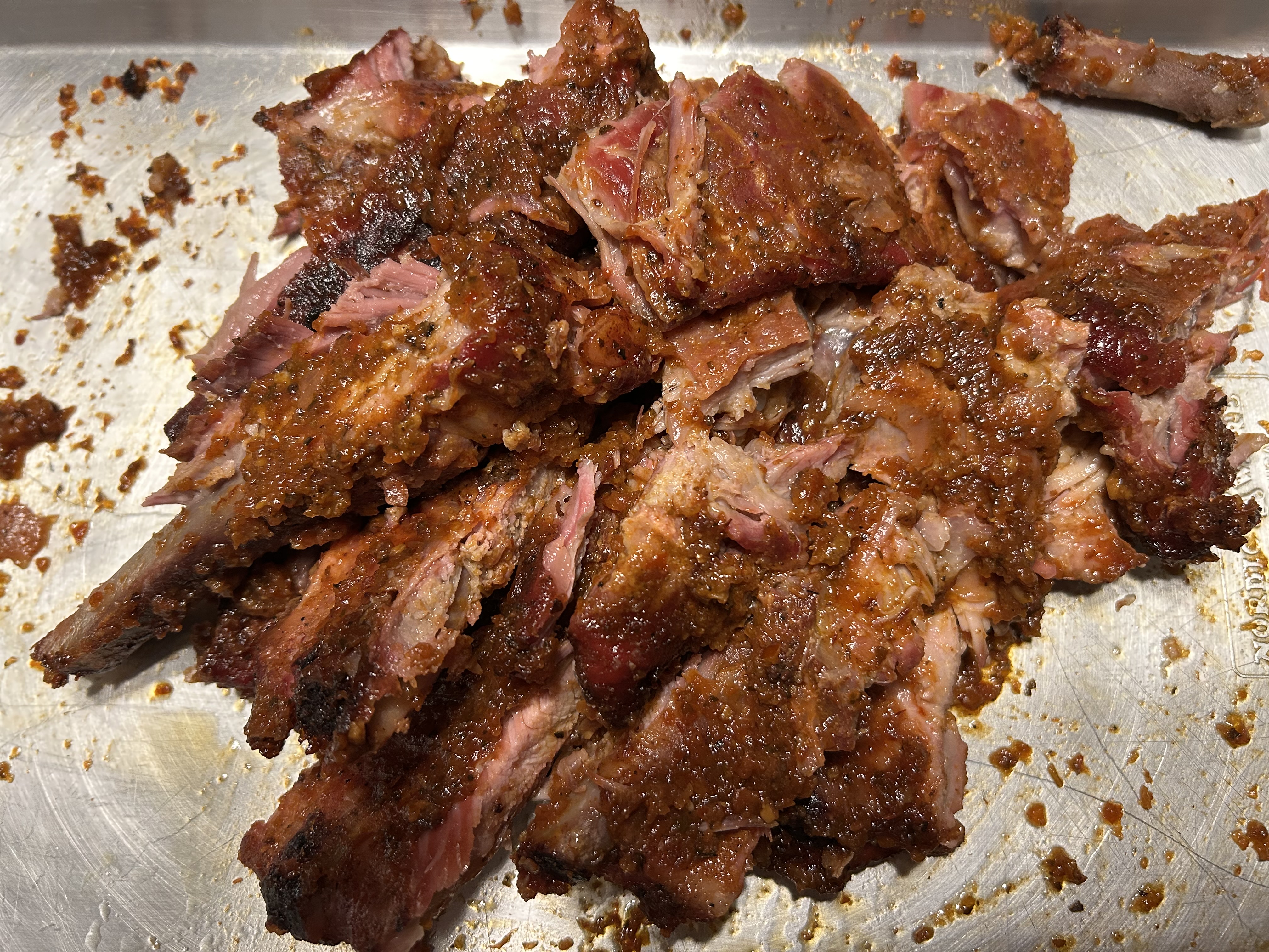 Smoked spare ribs with homemade red pepper n peach butter sauce. No fork necessary.